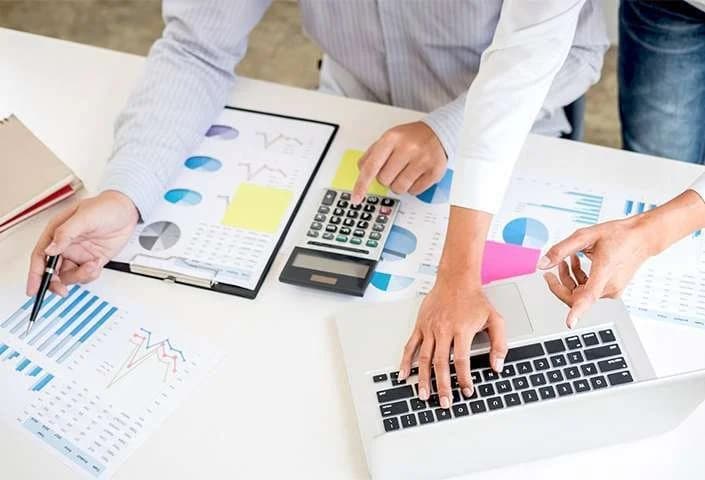 Two professionals reviewing accounting data